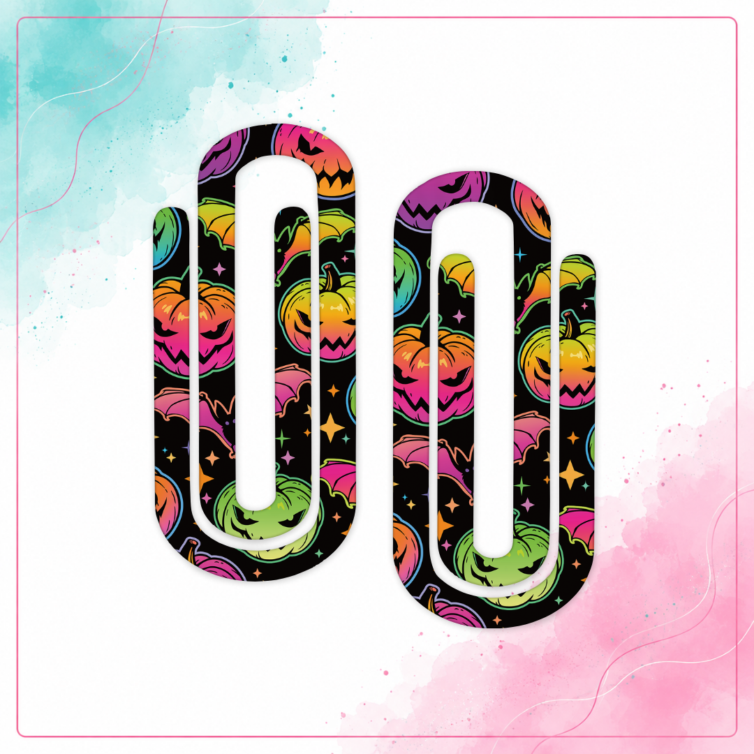 Two neon Halloween jumbo acrylic paper clips with colorful pumpkins, bats, and stars on black