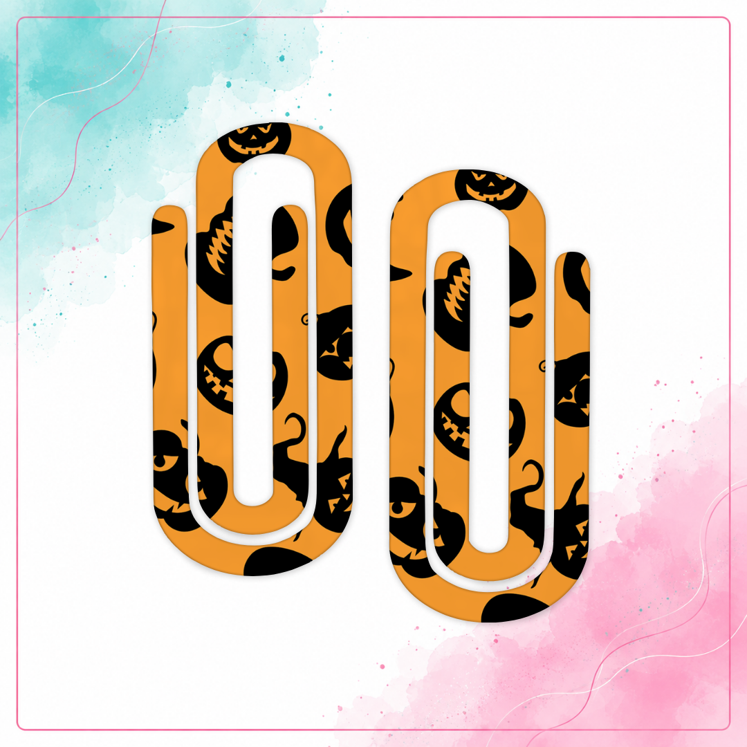 Spooky Pumpkin Silhouettes Jumbo Paper Clips with black jack-o’-lantern faces on an orange background